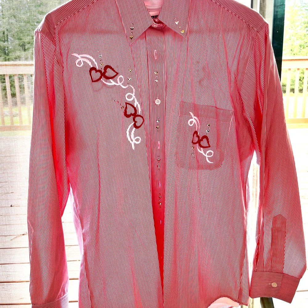 Women’s pink and white stripped button down shirt with white heart undershirt.